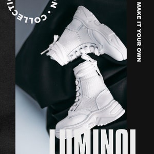 May include: A pair of white high-top trainers with a chunky sole and mesh detailing. The shoes are on a black surface with the text "COLLECTION" and "LUMINOl DESIGN" in white.