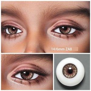 May include: Close-up of two brown eyes with long eyelashes. The eyes have a detailed iris pattern and are set against a light skin tone. The text "14/6mm ZA8" is visible.