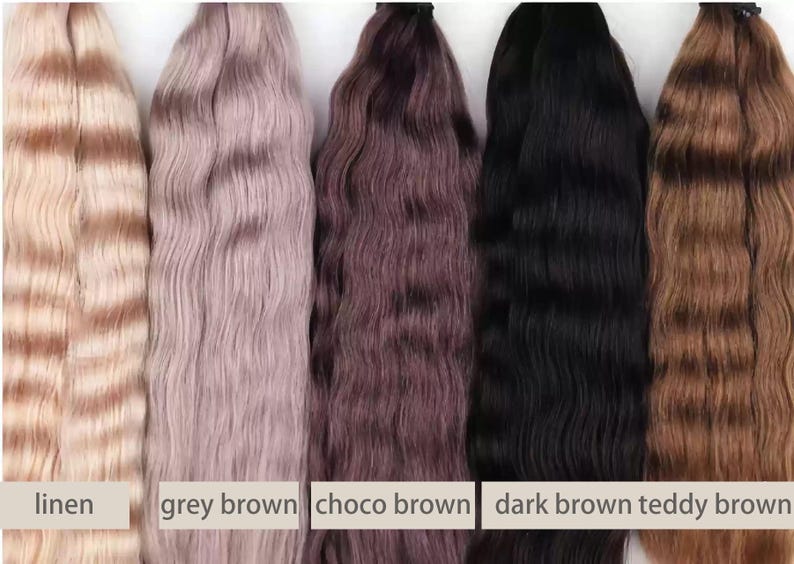 May include: Five bundles of wavy hair extensions in various colors. The colors include linen, grey brown, choco brown, dark brown, and teddy brown. Each bundle has a different shade, ranging from light beige to dark brown.