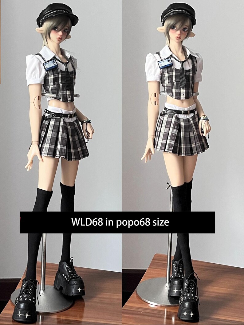 May include: A doll wearing a school uniform consisting of a white collared shirt, plaid vest and skirt, black knee-high socks, and platform shoes. The doll has elf-like ears and is wearing a black hat. The text "WLD68 in popo68 size" is displayed.