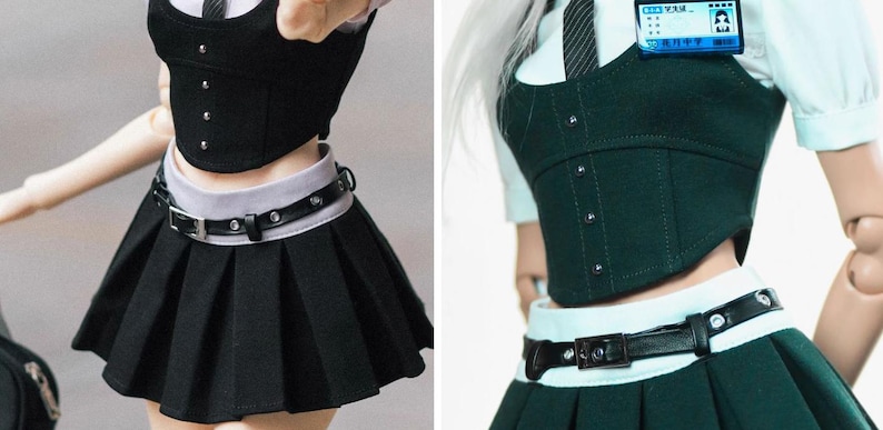 May include: A doll wearing a school uniform consisting of a black pleated skirt, a black corset-style top, and a white collared shirt. The outfit includes a black belt and a name tag. The uniform is designed with a focus on detail and style.