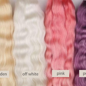 May include: Four bundles of wavy hair in golden, off-white, pink, and purple hues. Each bundle has a label with its color name. The golden hair is a light, warm blonde. The off-white hair is a bright, neutral shade. The pink hair is a vibrant, medium tone. The purple hair is a deep, cool tone.