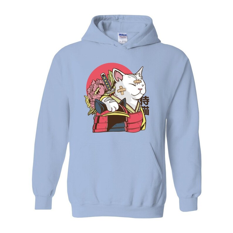 Peut inclure: Sweat-shirt bleu clair avec un chat blanc portant une tenue de samoura&iuml; rouge et noire. Le chat a un bandage sur l'&oelig;il et tient une &eacute;p&eacute;e. L'arri&egrave;re-plan est un cercle rouge avec une fleur rose.