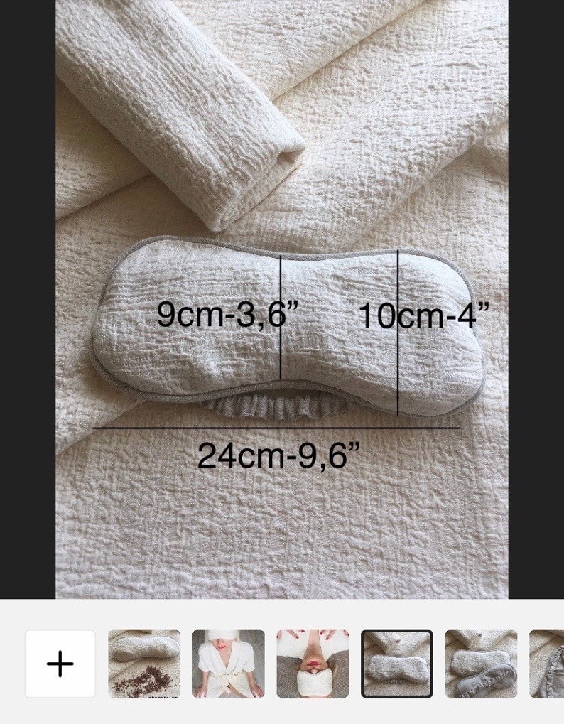 May include: A light gray eye mask with a white trim. The eye mask is 9 cm - 3.6 inches wide, 10 cm - 4 inches long, and 24 cm - 9.6 inches in circumference.