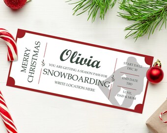 May include: A red and white Christmas gift certificate for a season pass for snowboarding. The certificate is addressed to Olivia and includes the start date of December 30th and the end date as TBD. The certificate also includes the message "Love, Dad & Mom".