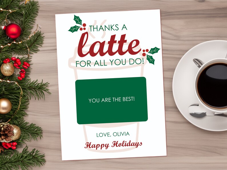 May include: A white card with a red and green coffee cup design. The text on the card reads "Thanks a latte for all you do!" and "You are the best!" with a green gift card area. The card is signed "Love, Olivia" and "Happy Holidays".