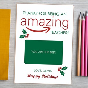 May include: A white card with a red and green holly design. The card says "Thanks for being an amazing teacher!" and "You are the best!" with a space for a gift card. The card also says "Love, Olivia" and "Happy Holidays".