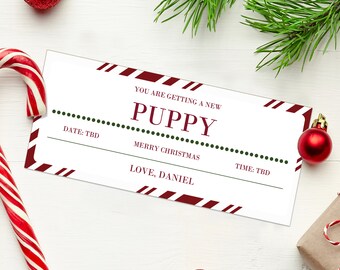 May include: A white Christmas-themed gift certificate with red and white striped accents. The text reads "YOU ARE GETTING A NEW PUPPY" and "MERRY CHRISTMAS". Includes space for date and time, and a signature line.