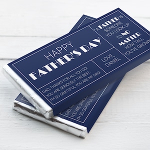 May include: A blue and white chocolate bar with the text "Happy Father's Day" and a message for Dad. The message reads: "Dad, thanks for all you do. You are seriously the best. I'm so grateful you are my Dad. Love, Daniel. A father is someone you look up to no matter how tall you've grown."