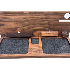 Minimalist desk with handcrafted Apple dock organizing iPhone, iPad, Apple Watch, and AirPods