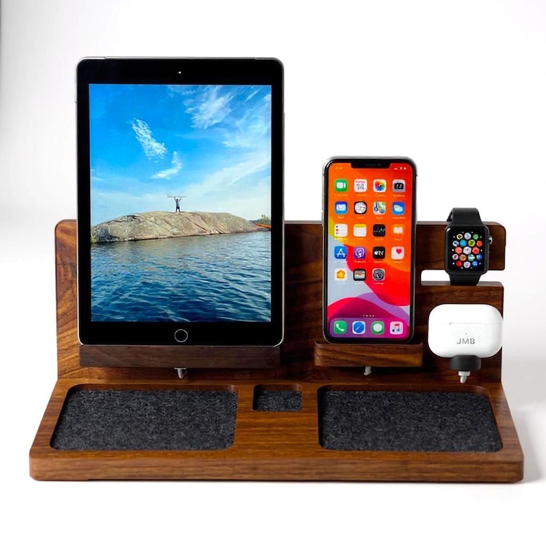 Wooden 4-in-1 Apple charging station shown with iPhone, iPad, AirPods, and Apple Watch docked. Handcrafted from walnut wood and designed to organize and charge all Apple devices in one elegant dock. Minimalist setup on a clean desk.
