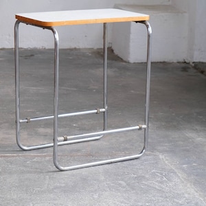 Tubular steel side table with white bakelite plate