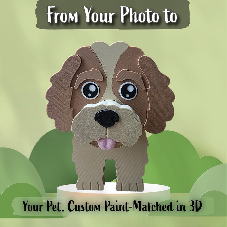 May include: A 3D printed dog figurine with brown and tan fur, large black eyes, a black nose, and a pink tongue. The text above reads "From Your Photo to" and the text below reads "Your Pet, Custom Paint-Matched in 3D".