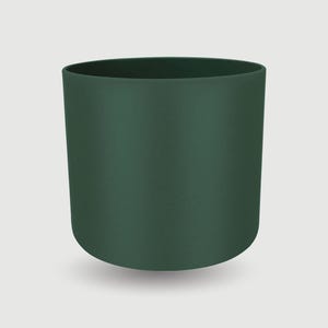 May include: A cylindrical, dark green planter with a smooth, matte finish. The planter has a rounded base and a wide opening at the top. The solid color and simple design make it suitable for various plants and decor styles.