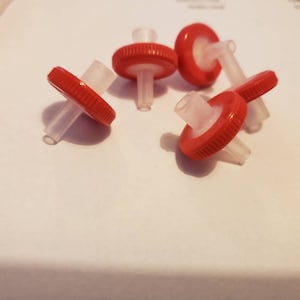 May include: Five red and white plastic filter caps with a clear plastic tube attached to each cap.