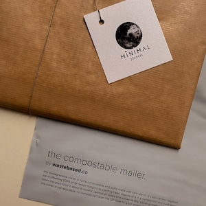 May include: A brown paper package tied with twine, featuring a tag with a black and white earth graphic and the text "MINIMAL planets." Below, a gray envelope reads "the compostable mailer" by wastebased.co, with descriptive text about its biodegradable nature.