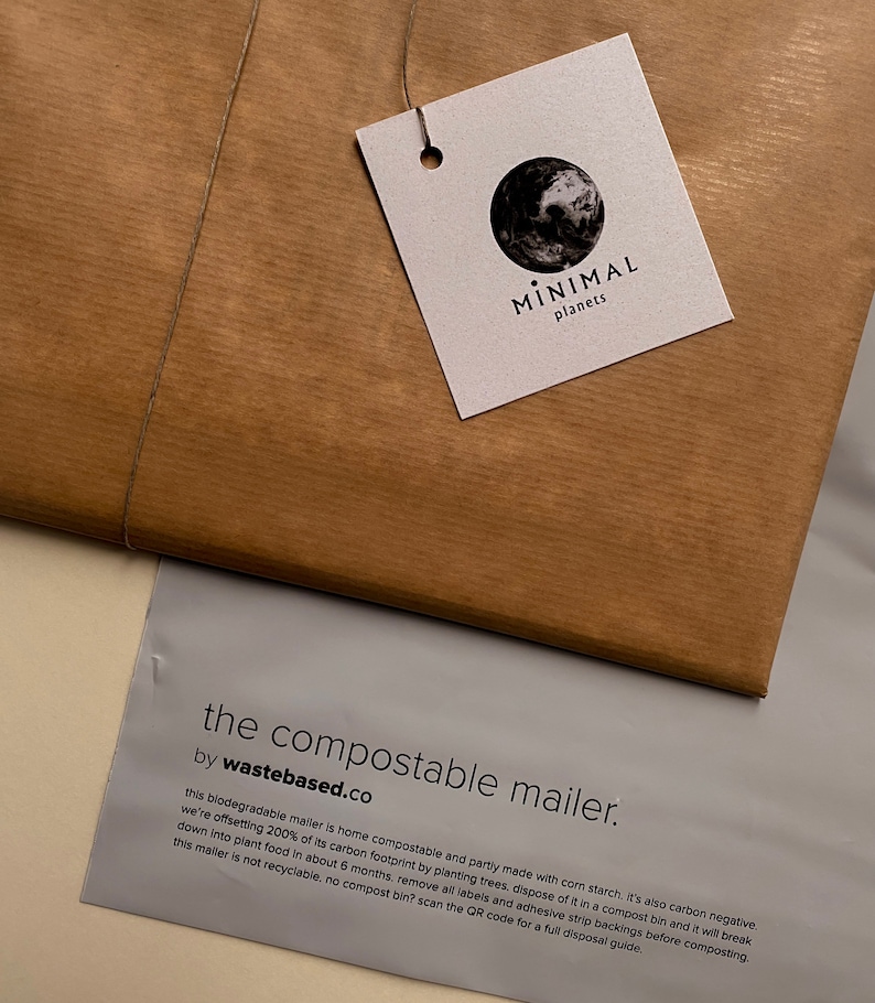 May include: A brown paper package tied with twine, featuring a tag with a black and white earth graphic and the text "MINIMAL planets." Below, a gray envelope reads "the compostable mailer" by wastebased.co, with descriptive text about its biodegradable nature.