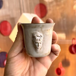 Handmade ceramic espresso cup with embossed Aphrodite relief, inspired by Greek mythology goddess design, green glaze finish, 100ml (3.4 oz) capacity, unique coffee mug for espresso lovers and mythology gift.