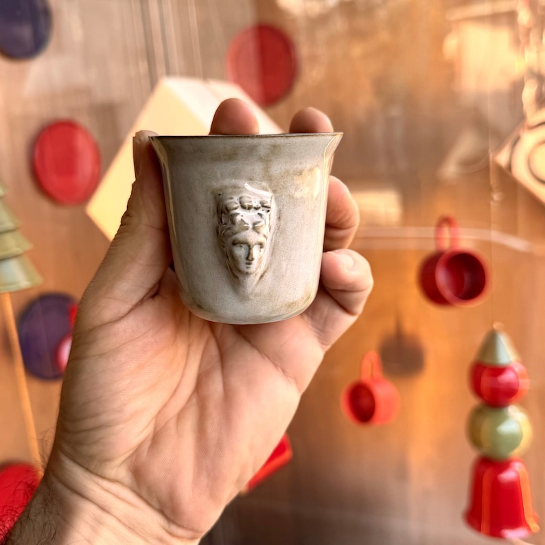 Handmade ceramic espresso cup with embossed Aphrodite relief, inspired by Greek mythology goddess design, green glaze finish, 100ml (3.4 oz) capacity, unique coffee mug for espresso lovers and mythology gift.