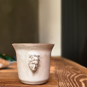 Handmade ceramic espresso cup with embossed Aphrodite relief, inspired by Greek mythology goddess design, green glaze finish, 100ml (3.4 oz) capacity, unique coffee mug for espresso lovers and mythology gift.