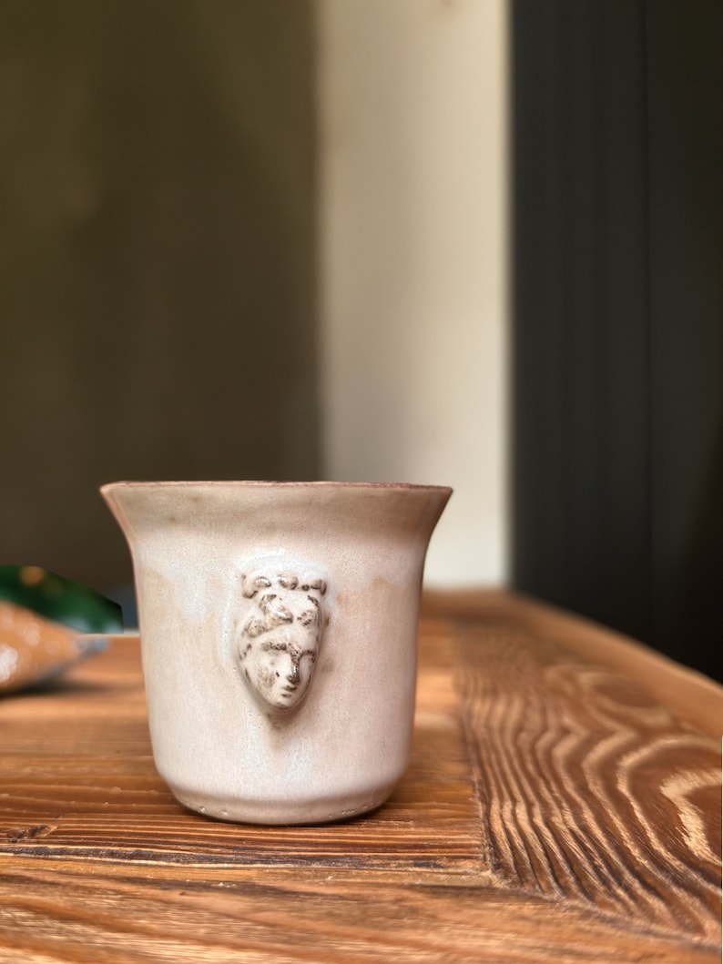 Handmade ceramic espresso cup with embossed Aphrodite relief, inspired by Greek mythology goddess design, green glaze finish, 100ml (3.4 oz) capacity, unique coffee mug for espresso lovers and mythology gift.