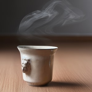 Handmade ceramic espresso cup with embossed Aphrodite relief, inspired by Greek mythology goddess design, green glaze finish, 100ml (3.4 oz) capacity, unique coffee mug for espresso lovers and mythology gift.