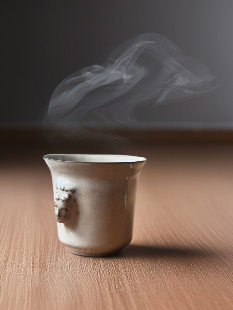 Handmade ceramic espresso cup with embossed Aphrodite relief, inspired by Greek mythology goddess design, green glaze finish, 100ml (3.4 oz) capacity, unique coffee mug for espresso lovers and mythology gift.
