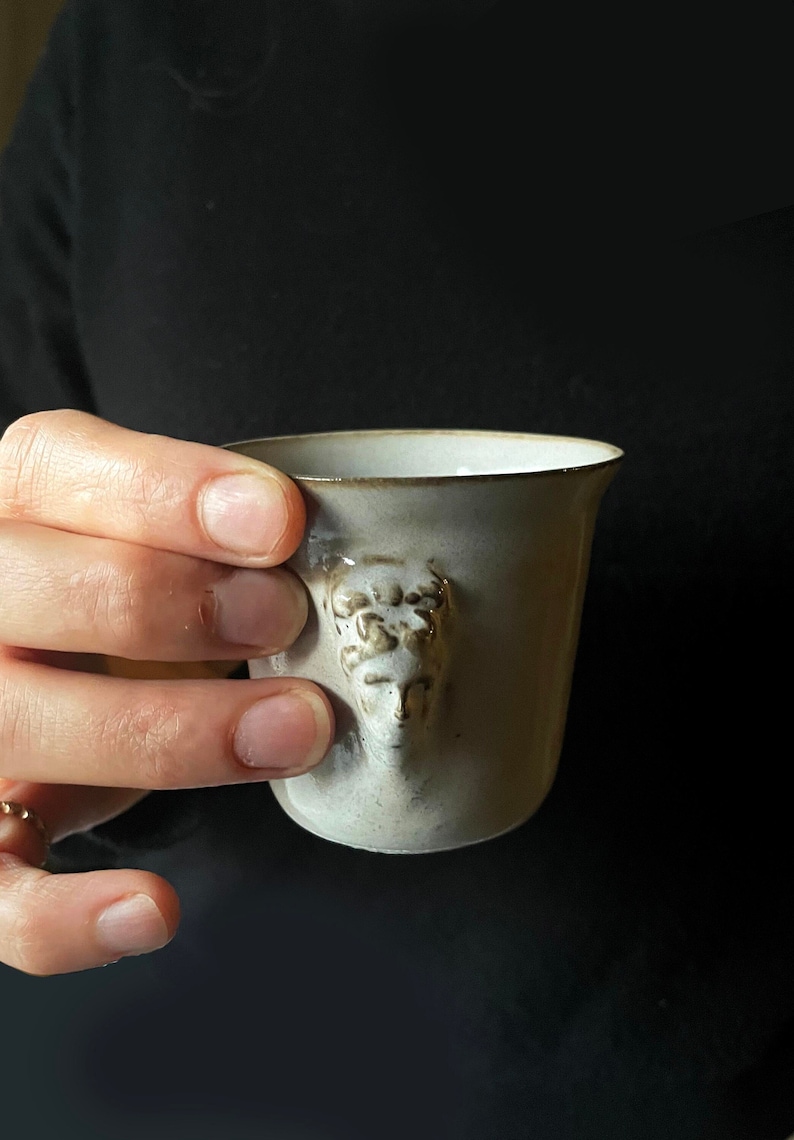 Handmade ceramic espresso cup with embossed Aphrodite relief, inspired by Greek mythology goddess design, green glaze finish, 100ml (3.4 oz) capacity, unique coffee mug for espresso lovers and mythology gift.