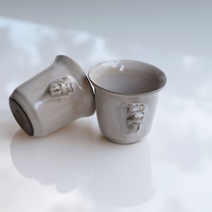 Handmade ceramic espresso cup with embossed Aphrodite relief, inspired by Greek mythology goddess design, green glaze finish, 100ml (3.4 oz) capacity, unique coffee mug for espresso lovers and mythology gift.