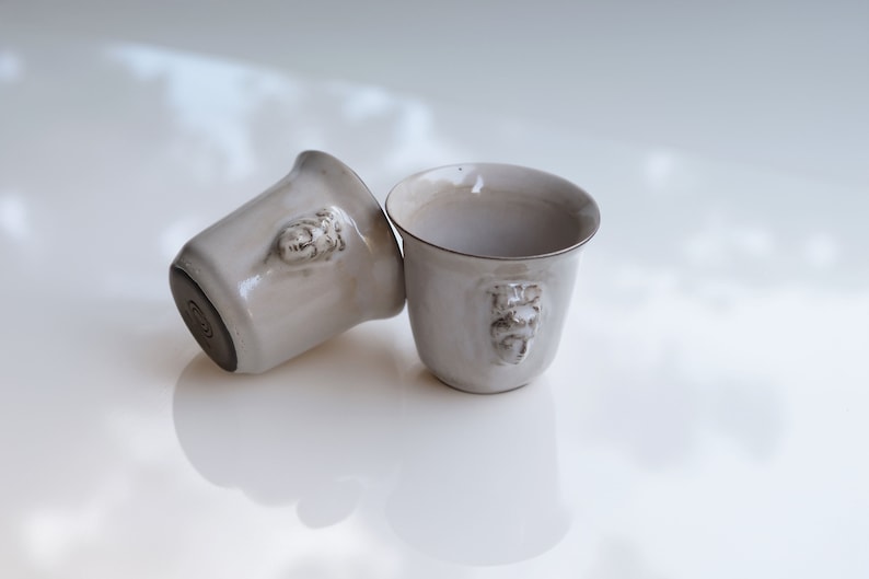 Handmade ceramic espresso cup with embossed Aphrodite relief, inspired by Greek mythology goddess design, green glaze finish, 100ml (3.4 oz) capacity, unique coffee mug for espresso lovers and mythology gift.