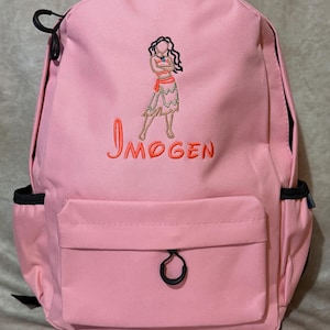 May include: Pink backpack with a front pocket and side pockets. The backpack features an embroidered design of a character and the name "Imogen" in orange. The backpack has black zips and accents.