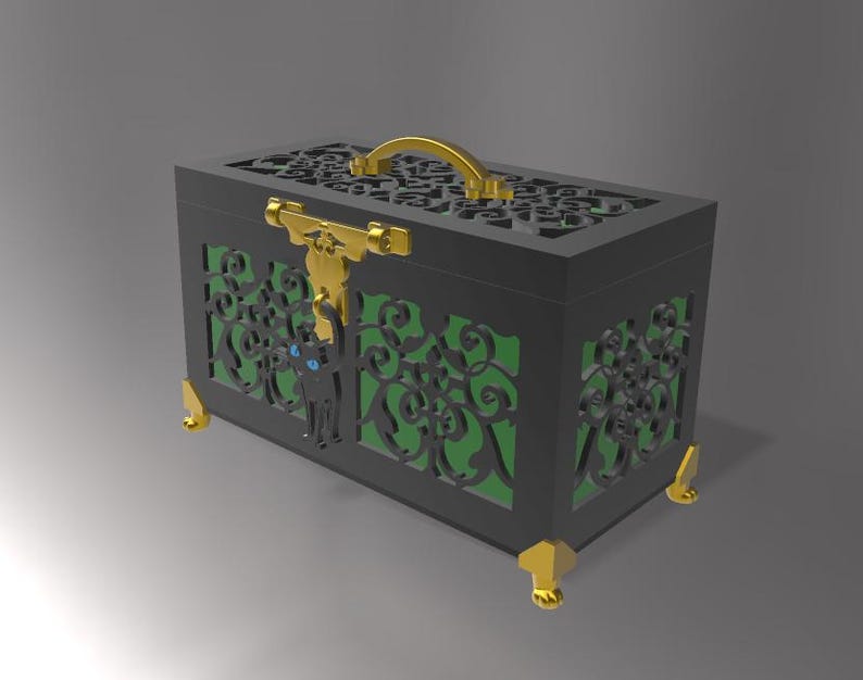 May include: A black decorative box with intricate cut-out designs and a gold handle. The box features gold accents on the corners and a gold clasp. A black cat silhouette with blue eyes is on the front. The interior is green.