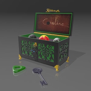 May include: A black and green decorative chest with gold accents, open to reveal a red and yellow ball, a gray ball, and a black ball. The chest has a green interior and the name "Coraline" is written on the inside of the lid. A green planchette and a key are in front.