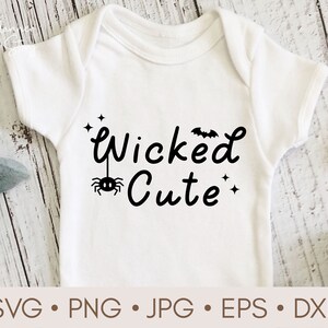 May include: White baby onesie with black text that reads "Wicked Cute" with a spider and bat graphic.