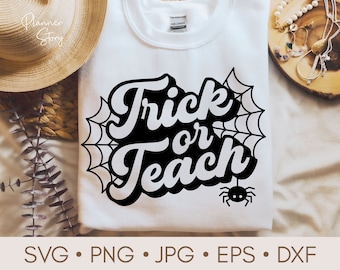 May include: A white t-shirt with a black and white graphic design that says "Trick or Teach" with a spider web and a spider in the design.
