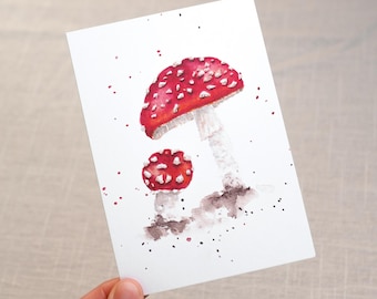May include: Watercolor painting of two red and white mushrooms with white spots on a white background. The larger mushroom is on the left and the smaller mushroom is on the right. The mushrooms are surrounded by small brown and black dots.