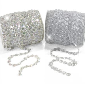 May include: Two spools of clear crystal bead garland. One spool has iridescent beads and the other has clear beads.