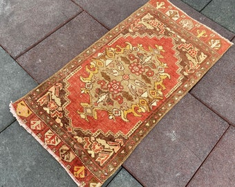 May include: A vintage Turkish rug with a red, brown, and cream color scheme. The rug has a floral pattern with intricate details.