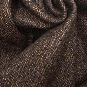 May include: Close-up of a brown and beige woven fabric with a herringbone pattern.