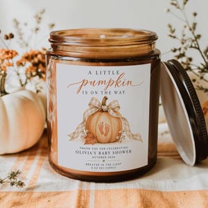 Peut inclure: Une bougie en pot de verre ambré avec une étiquette blanche illustrée d'une citrouille, un ruban vichy beige et le texte A LITTLE pumpkin IS ON THE WAY, THANK YOU FOR CELEBRATING OLIVIA'S BABY SHOWER OCTOBER 2026 BREATHE IN THE LIGHT 227g SOY CANDLE.
