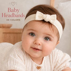 May include: A cream-coloured baby headband featuring a small, centred fabric bow. The text on the image reads Baby Headbands 34 COLOURS with a heart icon. The headband is made of a soft, stretchy material and is worn around the head.
