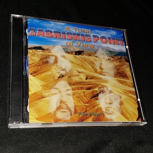 May include: A CD case with a yellow and brown desert landscape image. The text "A Total Zabriskie Point of View" is at the top of the image. The text "Pink Floyd" is at the bottom of the image.