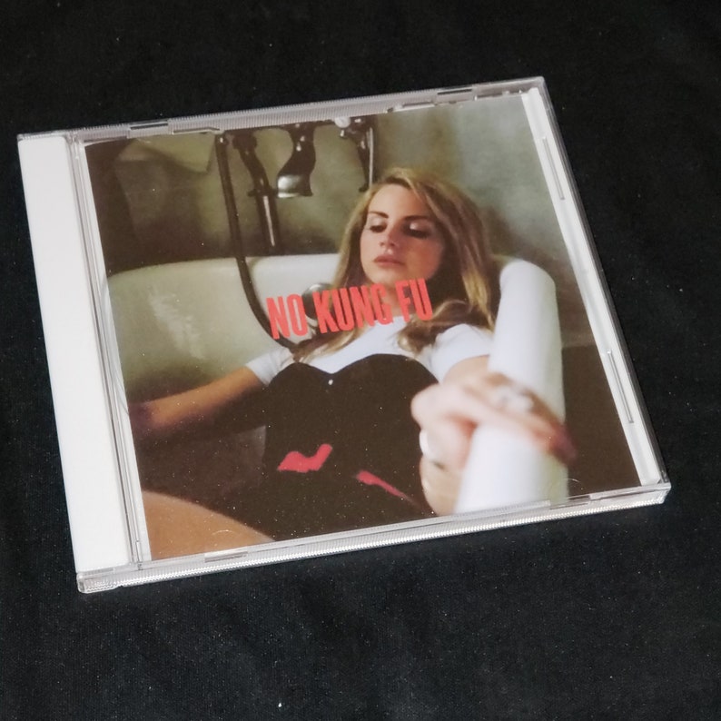 May include: A CD case with a white background and a photo of a woman in a bathtub. The text "NO KUNG FU" is printed in red on the front of the case.