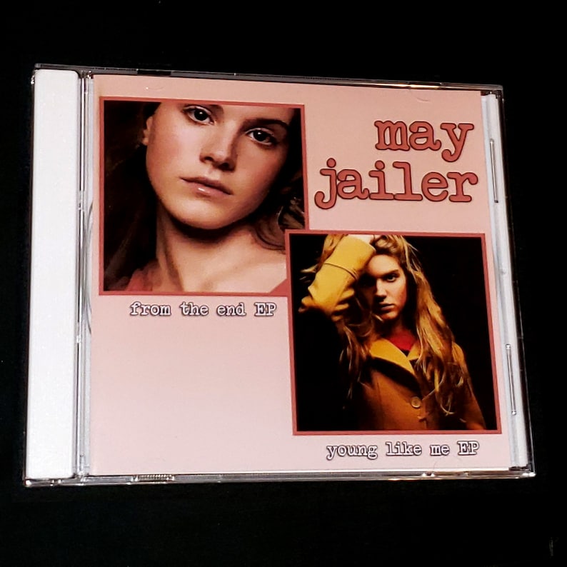 May include: A pink and white CD case with a photo of a woman on the front. The text "may jailer" is in large, pink letters. The text "from the end EP" is in smaller, white letters. The text "young like me EP" is in smaller, white letters.