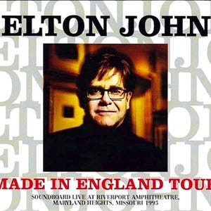 May include: Album cover featuring Elton John with text "ELTON JOHN" at the top. The image includes a portrait of Elton John wearing glasses. Below the portrait, the text reads "MADE IN ENGLAND TOUR". Additional text indicates a live performance in Missouri in 1995.