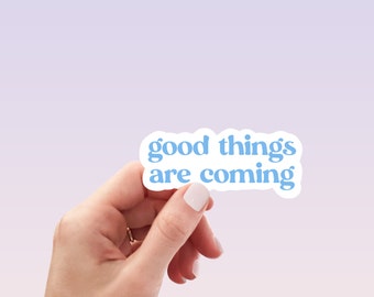 May include: A white sticker with blue text that reads "good things are coming".
