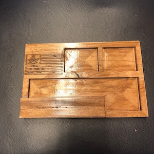 May include: A wooden tray with four compartments, one of which has a leaf design burned into the wood.