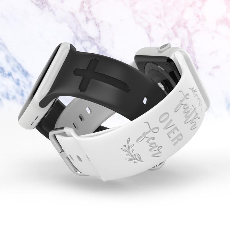 May include: Two Apple Watch bands, one black with a cross design and one white with the text "Faith Over Fear" and a floral design.
