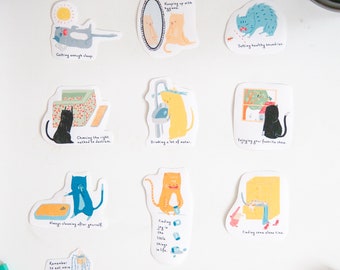 May include: A set of 10 illustrated stickers featuring cats with different life advice. The stickers are white with colourful illustrations and text. The text includes phrases like "Getting enough sleep", "Keeping up with hygiene", "Setting healthy boundaries", "Choosing the right method to destress", "Drinking a lot of water", "Enjoying your favourite show", "Always cleaning after yourself", "Finding joy in the little things in life", "Finding some alone time", "Remember to eat more veggies", "Focusing on the task on hand", and "Be real with your needs".
