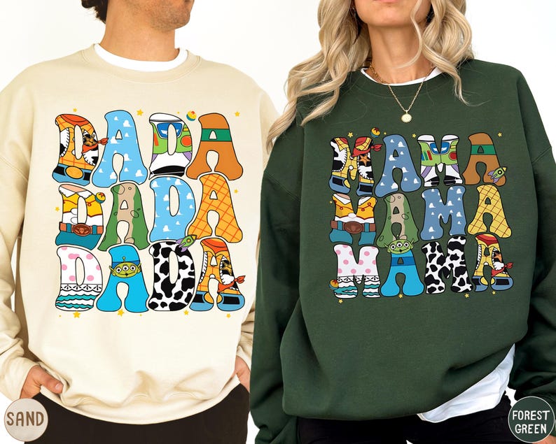 two people wearing sweatshirts with colorful, cartoon-style text.